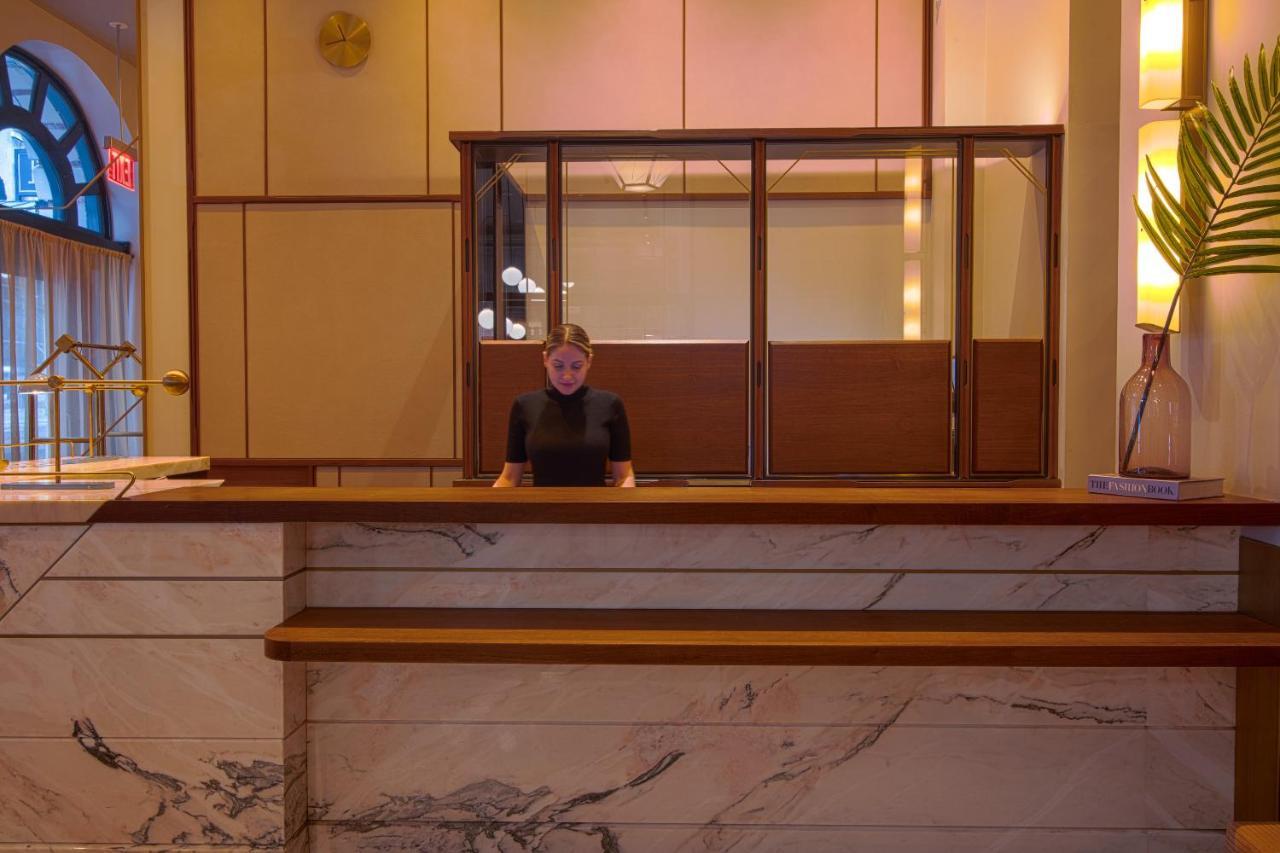 Hotel The Evelyn Nomad New York Esterno foto A hotel receptionist at the front desk